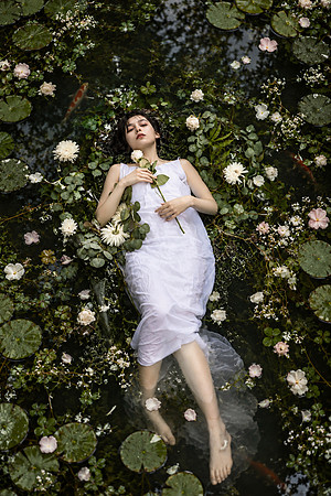 Dreamy Woman Floating Among Water Lilies