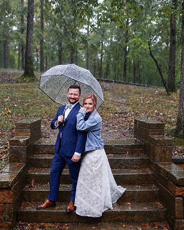 Rainy Wedding Portrait Under Umbrella