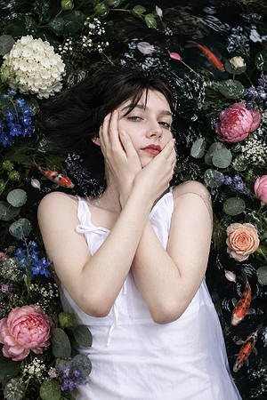 Woman Floating Among Flowers and Koi-1